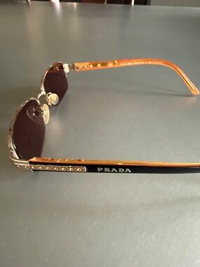 PRADA Women’s bifocal glasses. Gold rims amber rhinestones on Temple bars.
